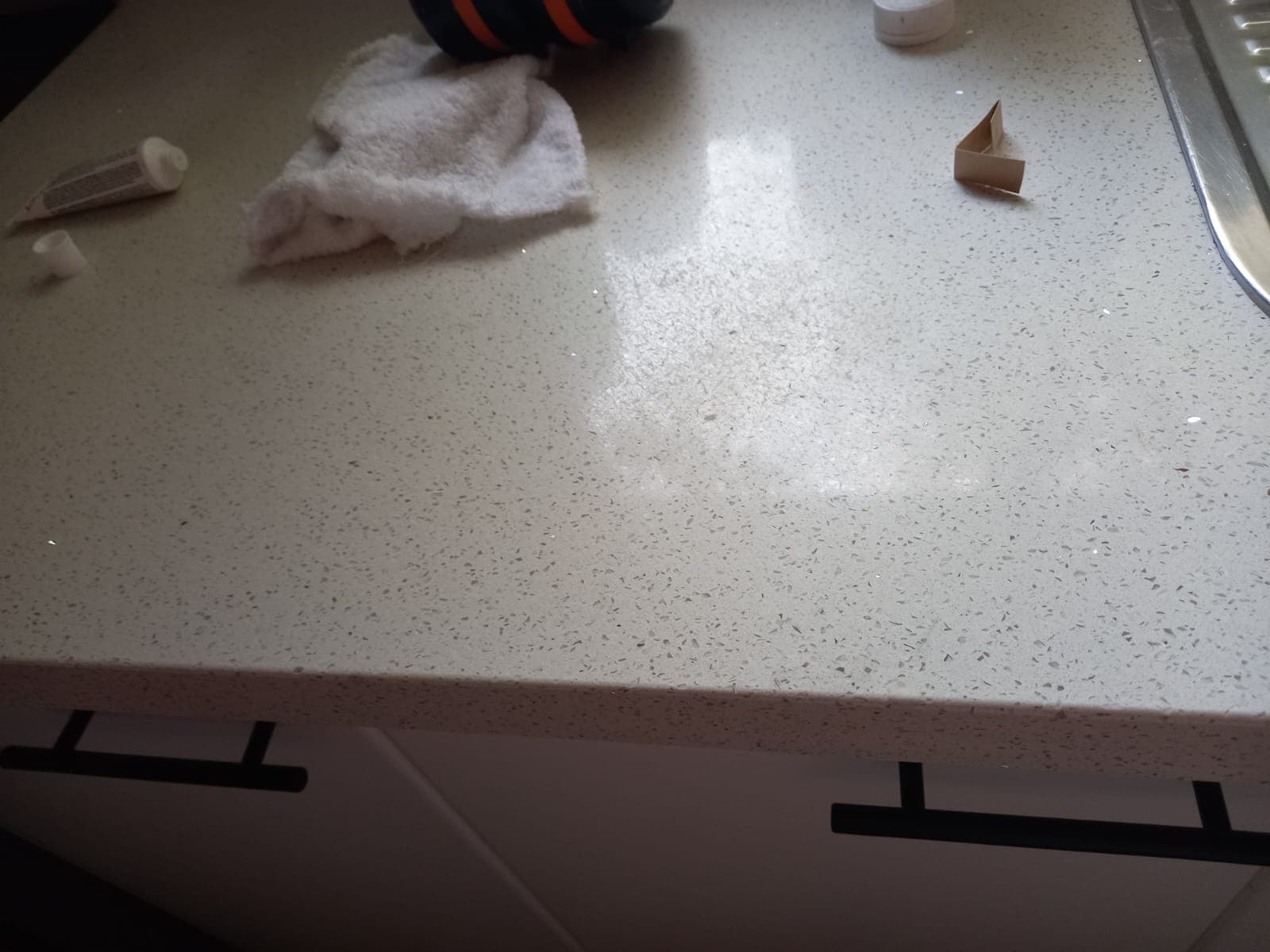 After: the engineered stone benchtop with the chip filled and the surface even again.