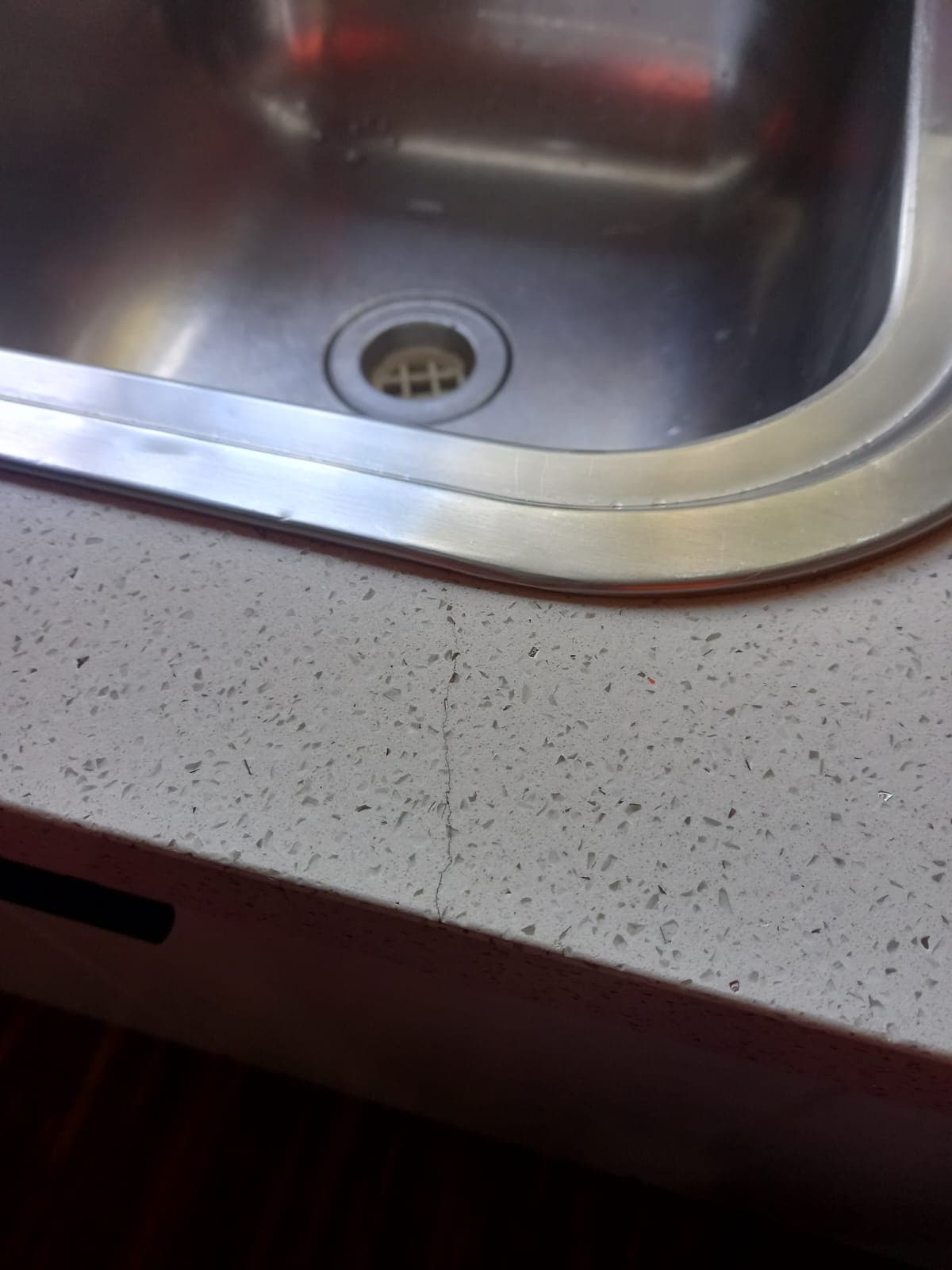 Before: a crack in a white engineered stone benchtop.