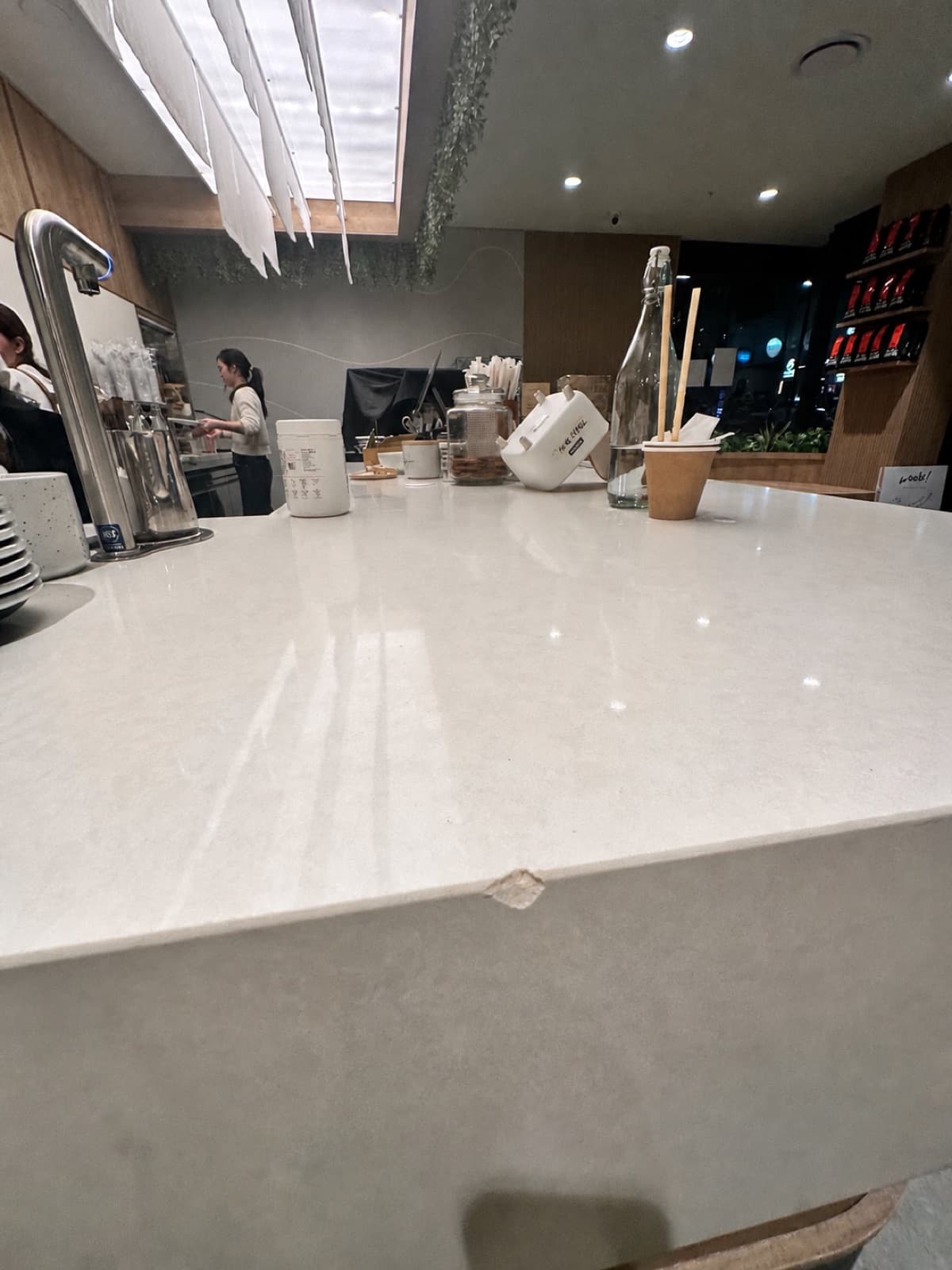 Before: a chip on the front edge of a white stone cafe counter.
