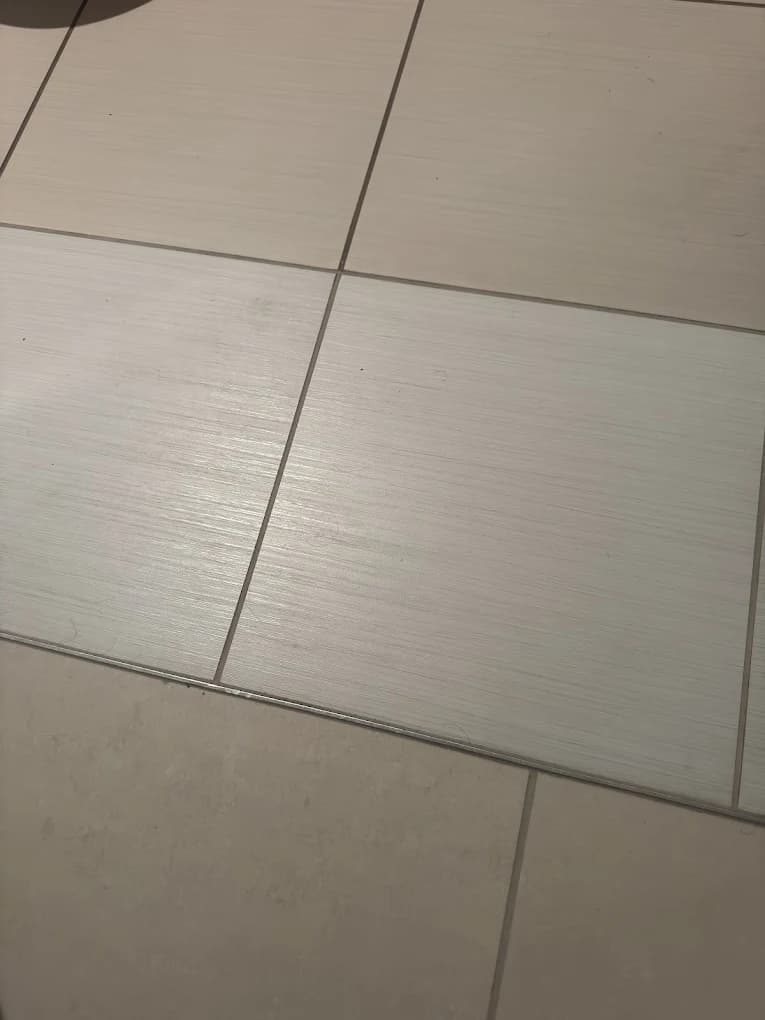 A floor tile after repair, from a customer review.